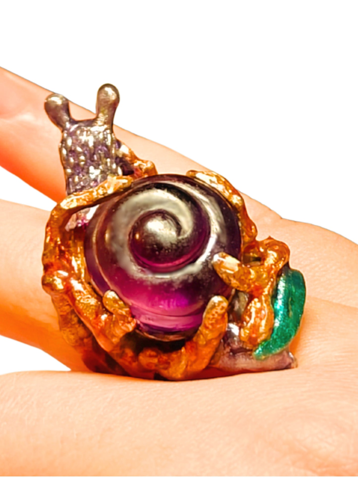 Another angle of the Amethyst Wanderer ring from the Stone Garden Collection by Konforti Jewelry, showing the 960 silver craftsmanship, spiral snail shell carved from 29 ct lab-grown amethyst, and vivid hand-painted Limoges enamel artistry.