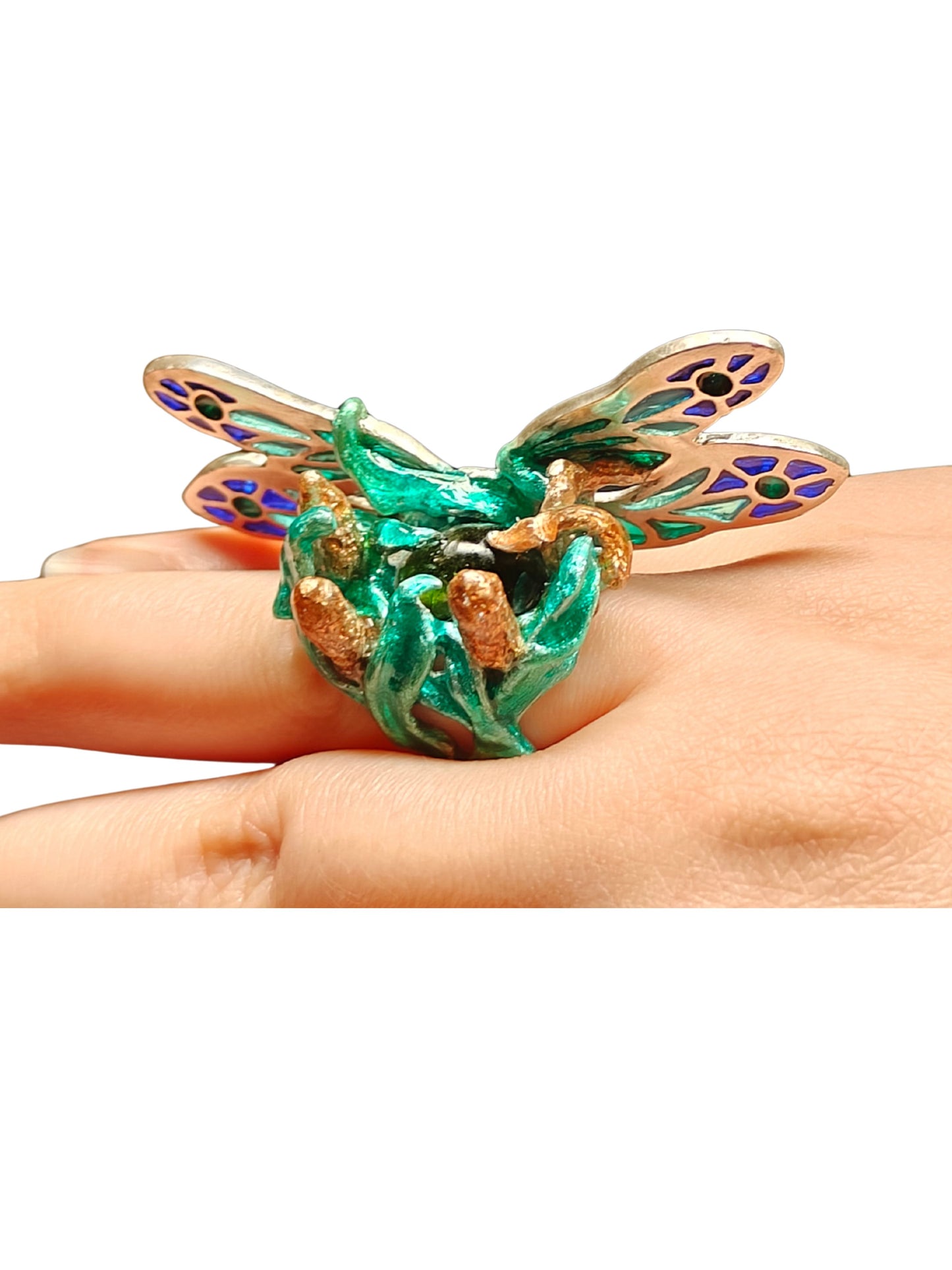 Close-up of the Enchanted Dragonfly ring worn on a hand from the Stone Garden Collection by Konforti Jewelry, featuring a 7.5 ct green tourmaline gemstone and plique-à-jour enamel wings handcrafted in 960 silver, evoking the magic of movement and light.