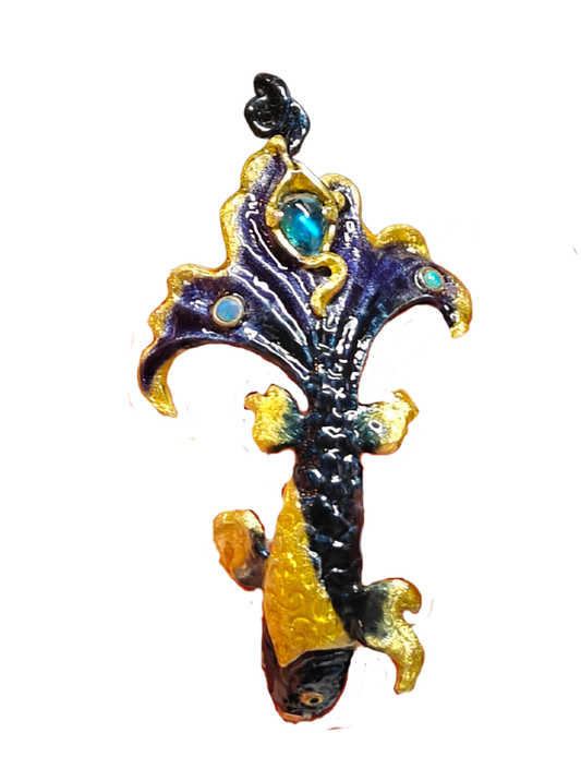 The Ocean Duet pendant from the Stone Garden Collection by Konforti Jewelry, handcrafted in 960 silver and adorned with 3 ct blue topaz and 0.01 ct opal gemstones. Hand-painted Limoges enamel creates flowing ocean-inspired color and movement.