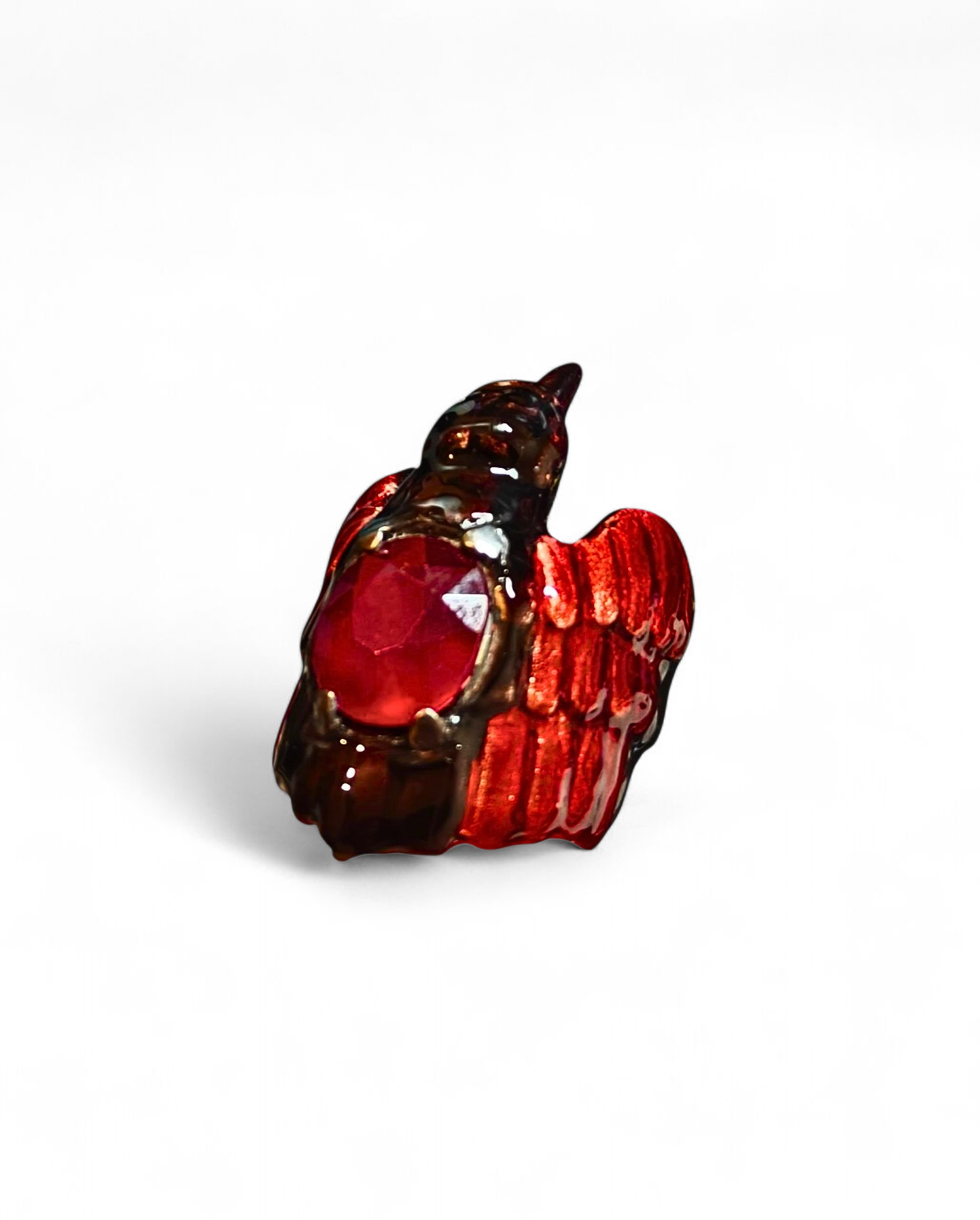 Front view of the Royal Raven ring from the Stone Garden Collection by Konforti Jewelry, handcrafted in 960 silver and crowned with an 8.45 ct treated ruby. The design features Limoges-style hot enamel paintings and 24K gold plating that give the piece depth, contrast, and regal character.