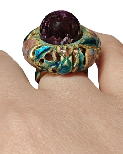 Close-up of amethyst gemstone set in 18K gold with intricate hot enamel artwork, fine craftsmanship by Konforti Jewelry
