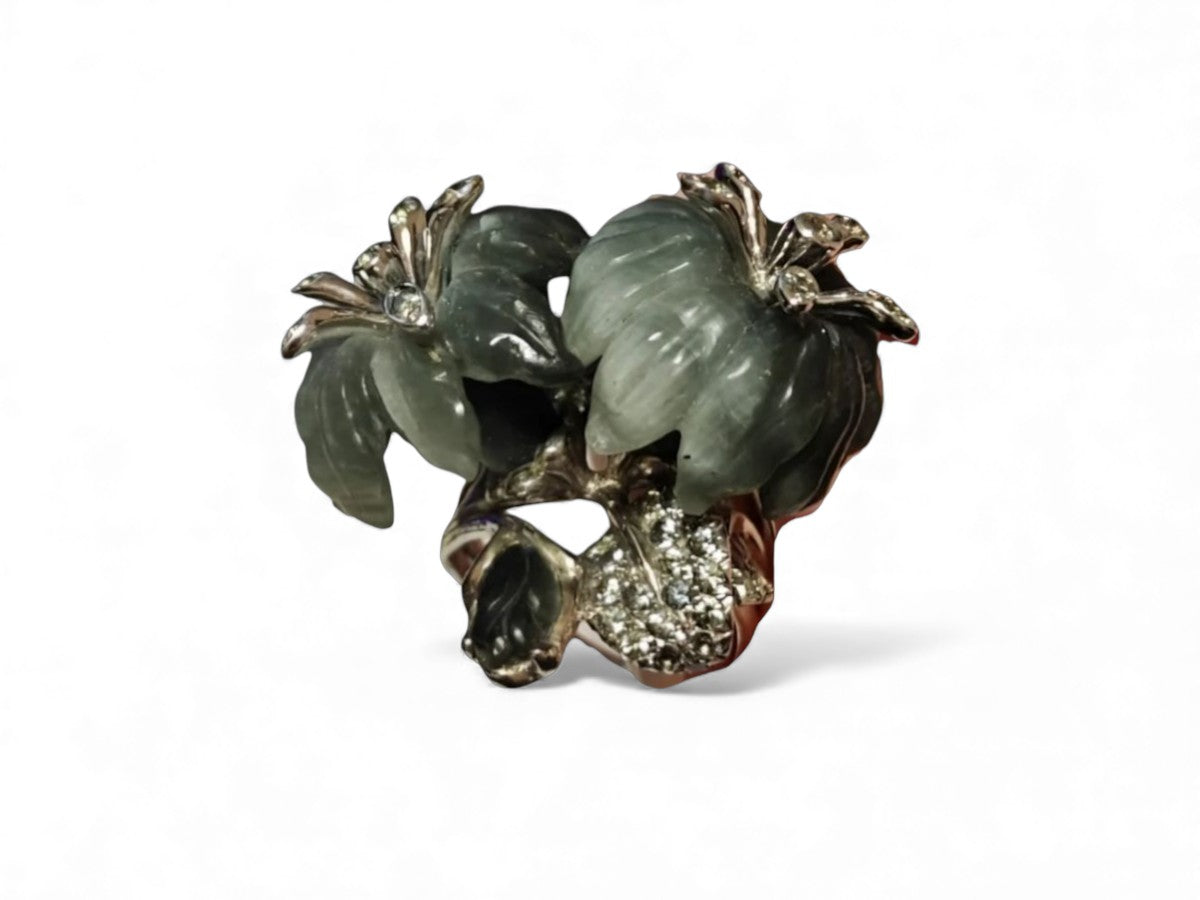 Close-up image of the Asian Lilly ring capturing the detailed carving of the cat’s eye gemstone flowers and the grey sapphires set in rhodium-plated 18K white gold.