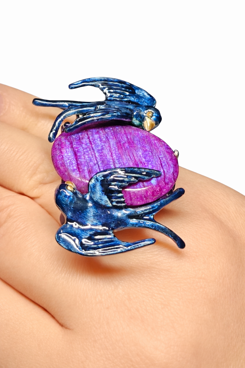 Celestial Flight ring by Konforti Jewelry featuring a 33 carat purple moonstone set in 960 silver with Limoges hot enamel swallows and 24K gold accents shown on hand