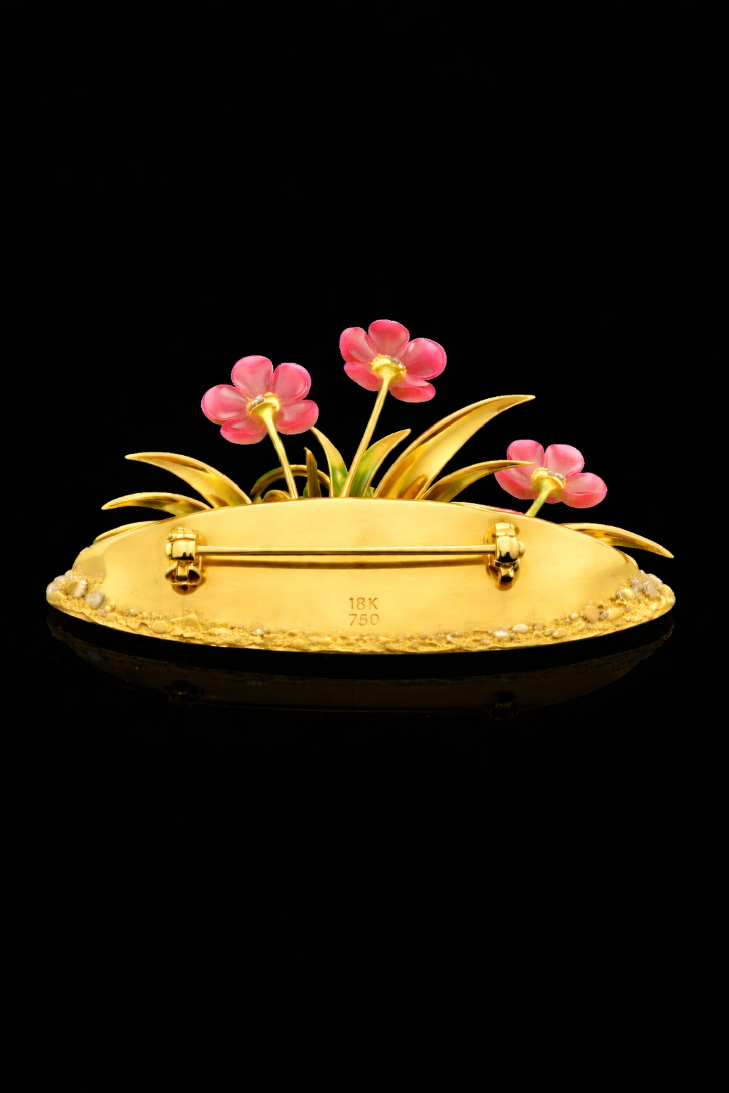 Back view of the Blooming Harmony 18K gold floral brooch showing the handcrafted gold structure, hallmarks, and secure pin mechanism.