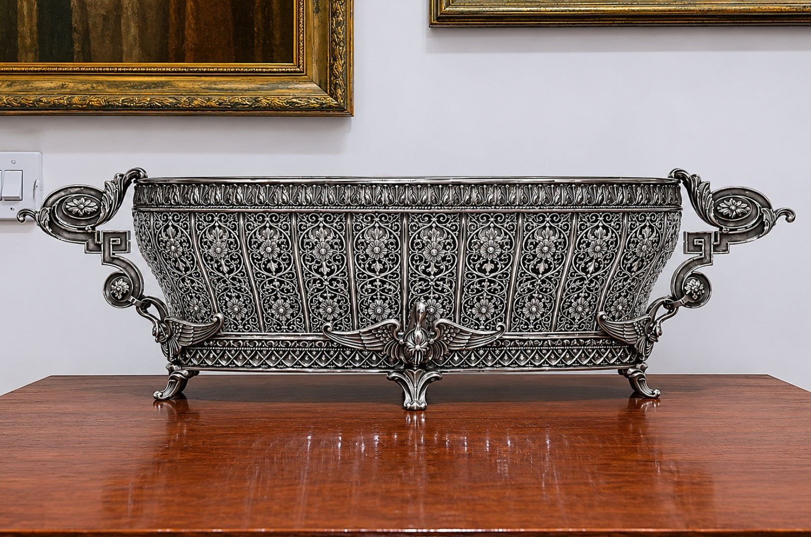 Monumental Swan Fidelity sterling silver centerpiece vase displayed in an atelier setting, featuring elaborate openwork panels, sculpted swans, and Fabergé-inspired Imperial design.