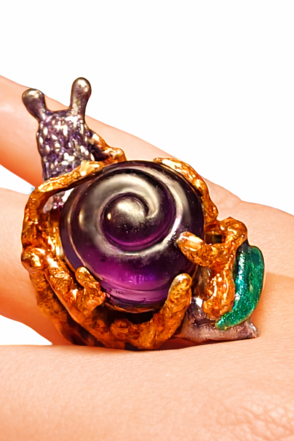 Closeup of 29ct carved amethyst snail shell ring with copper tone enamel and green enamel base handcrafted in 960 silver by Konforti Jewelry