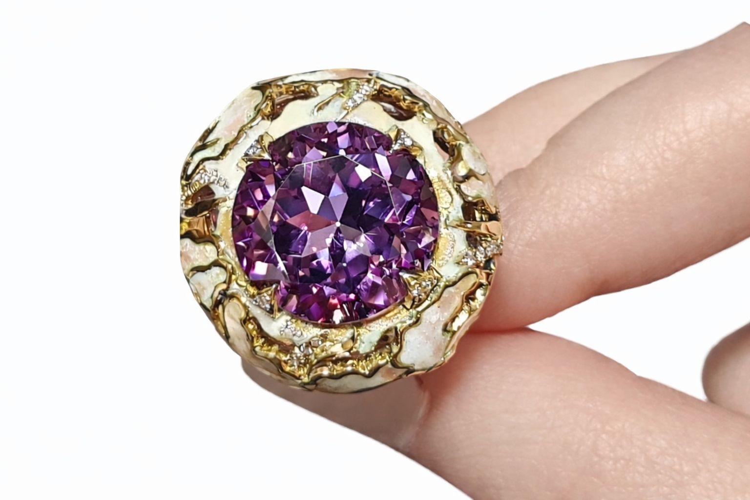 Close up of Floral Fantasy ring by Konforti Jewelry showing 32ct ametrine gemstone set in 18K yellow gold with hand painted enamel lily flowers pink sapphires and diamond accents worn on hand.