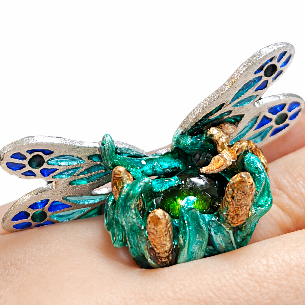 Handcrafted dragonfly ring in 960 silver with vivid green tourmaline center stone, plique a jour enamel wings and hot enamel details shown worn on hand by Konforti Jewelry