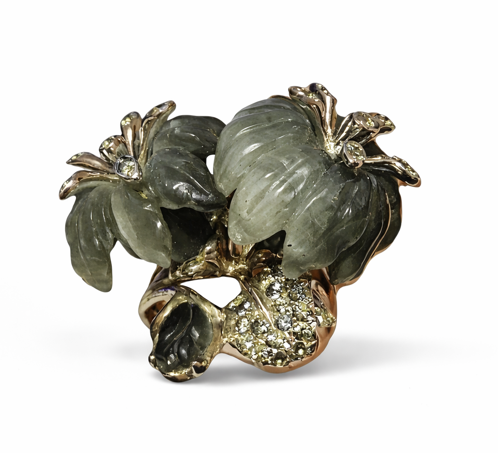 Angled view of the Asian Lilly ring on hand, showing sculptural cat’s eye stone flowers and grey sapphire details