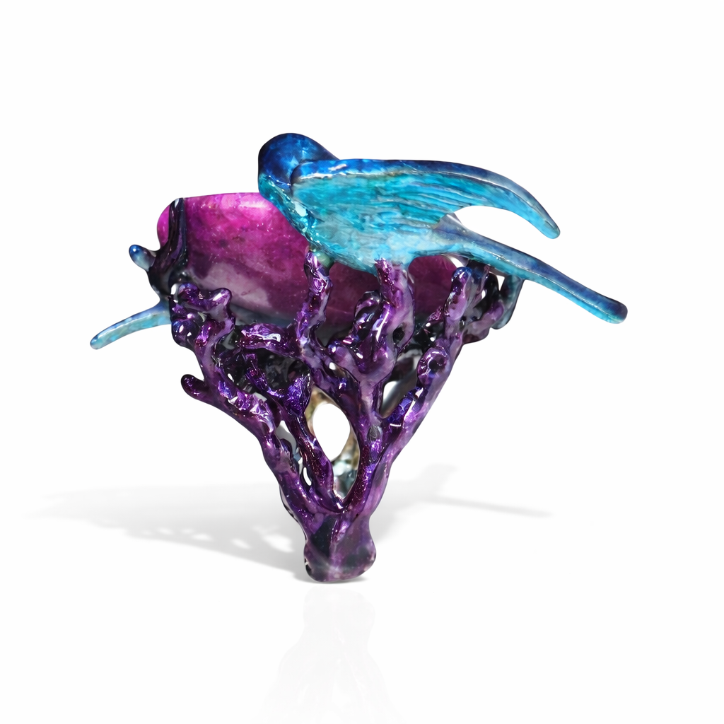 Angled view of Celestial Flight ring featuring large purple moonstone surrounded by enamel swallows in 960 silver artistic handcrafted jewelry design
