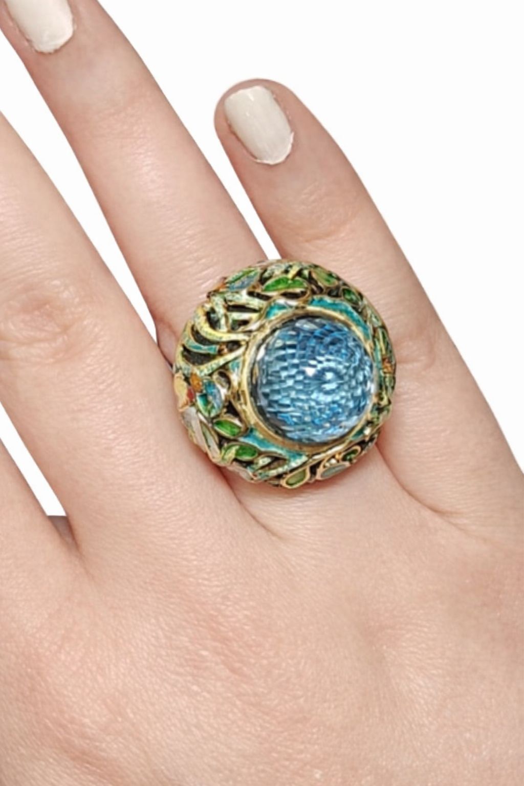 Shimmering Pond cocktail ring worn on hand, featuring a clear Swiss topaz set in 18K yellow gold with green enamel accents