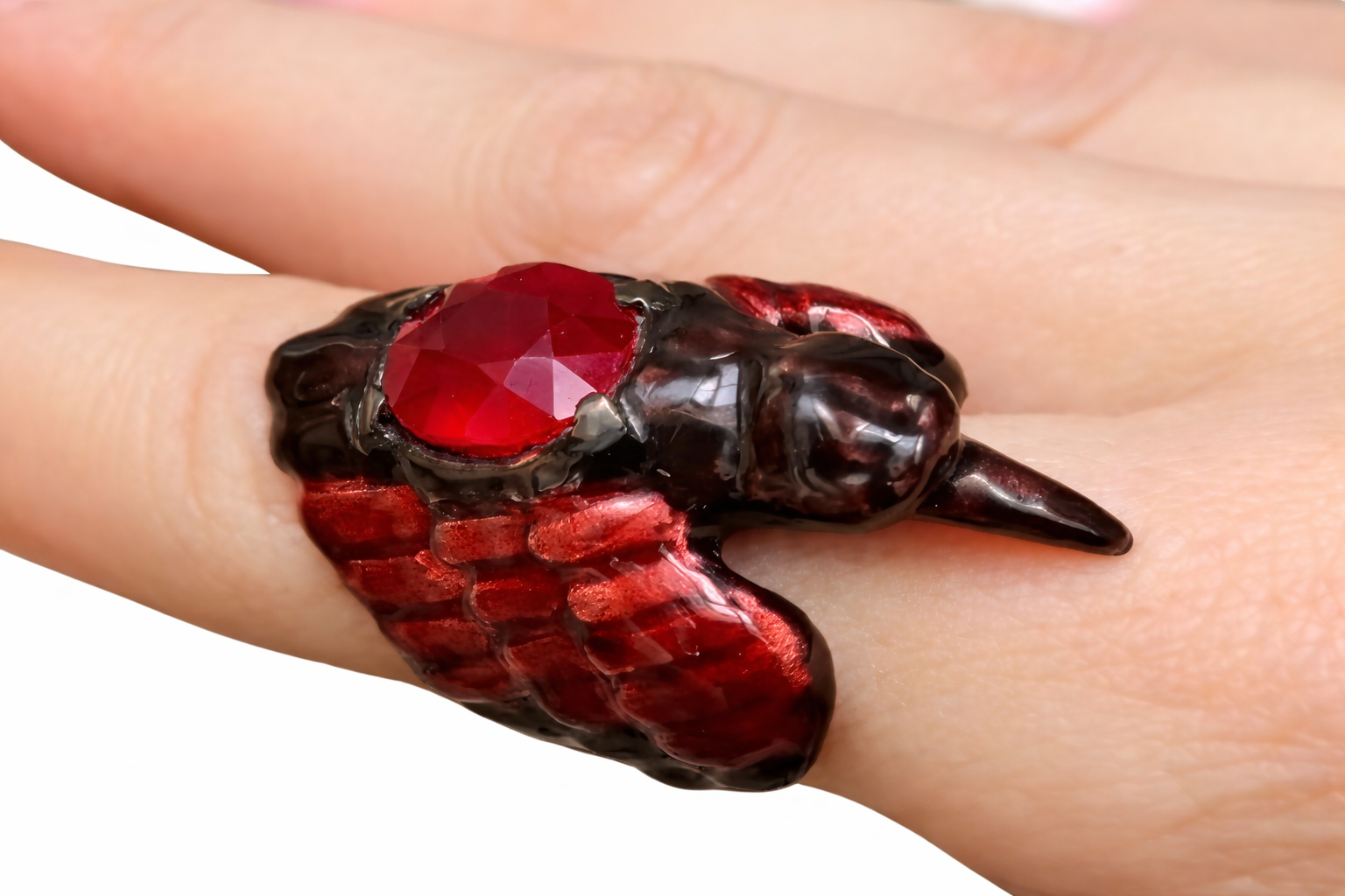 Royal Raven ruby statement ring on hand in 960 silver with red enamel wings and carved gemstone center from Stone Garden Collection