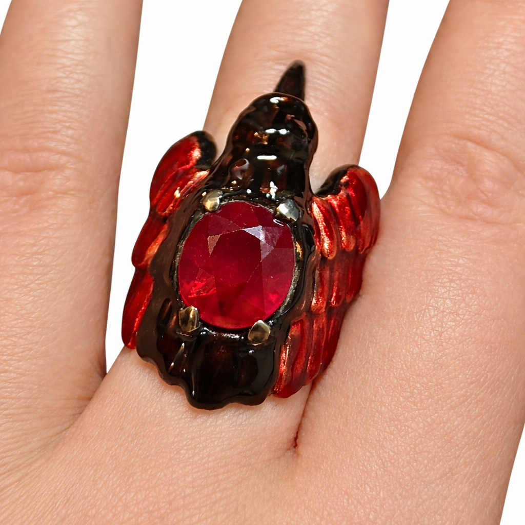 Artisan ruby raven ring with luminous hot enamel wings and sculptural silver setting by Konforti Jewelry