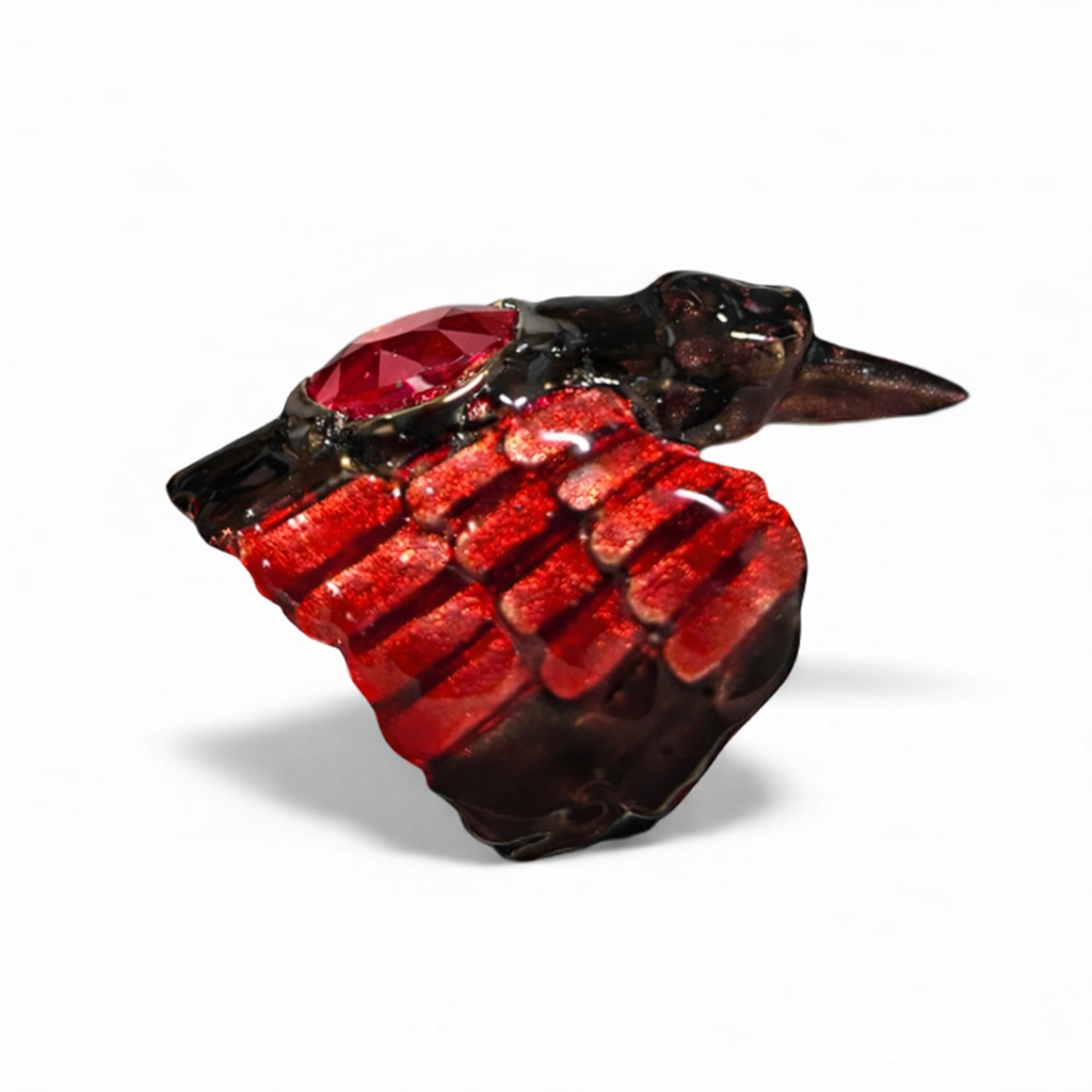 Side view of Royal Raven ring showing deep red enamel wings and faceted ruby center in handcrafted silver design