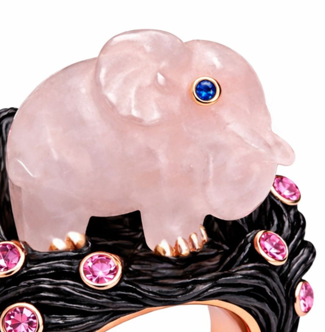 Close up of hand carved rose quartz elephant with blue sapphire eye in luxury cocktail ring design