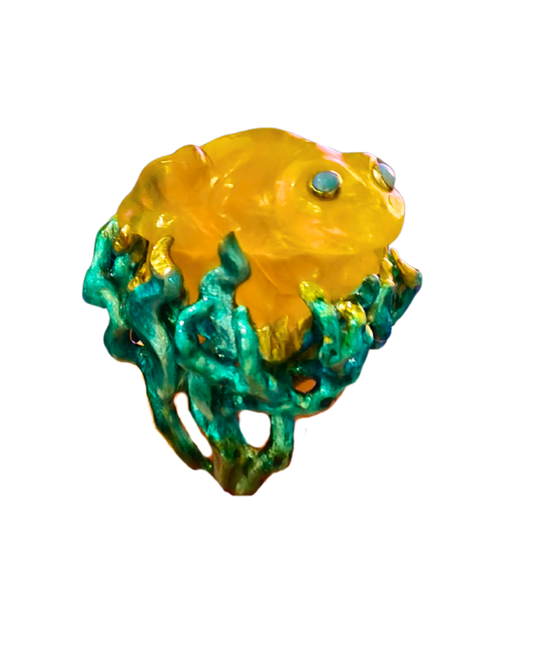 The Kelp Dancer ring by Konforti Jewelry from the Stone Garden Collection, featuring a 100 ct yellow lepidolite frog carving with opal eyes, handcrafted in 960 silver with hand-painted Limoges enamel that evokes the flowing movement of kelp underwater.