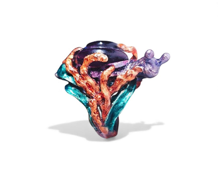 Front view of the Amethyst Wanderer ring from the Stone Garden Collection, featuring a 29ct lab-grown amethyst carved into a spiral snail shell and set on a 960 silver base adorned with vivid hand-painted Limoges-style enamel.