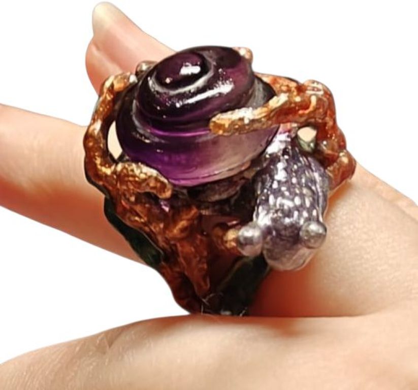 Side view of Amethyst Wanderer ring on hand, showcasing spiral snail-shell amethyst carving, detailed 960 silver work, and layered hand-painted enamel from the Stone Garden Collection by Konforti Jewelry.