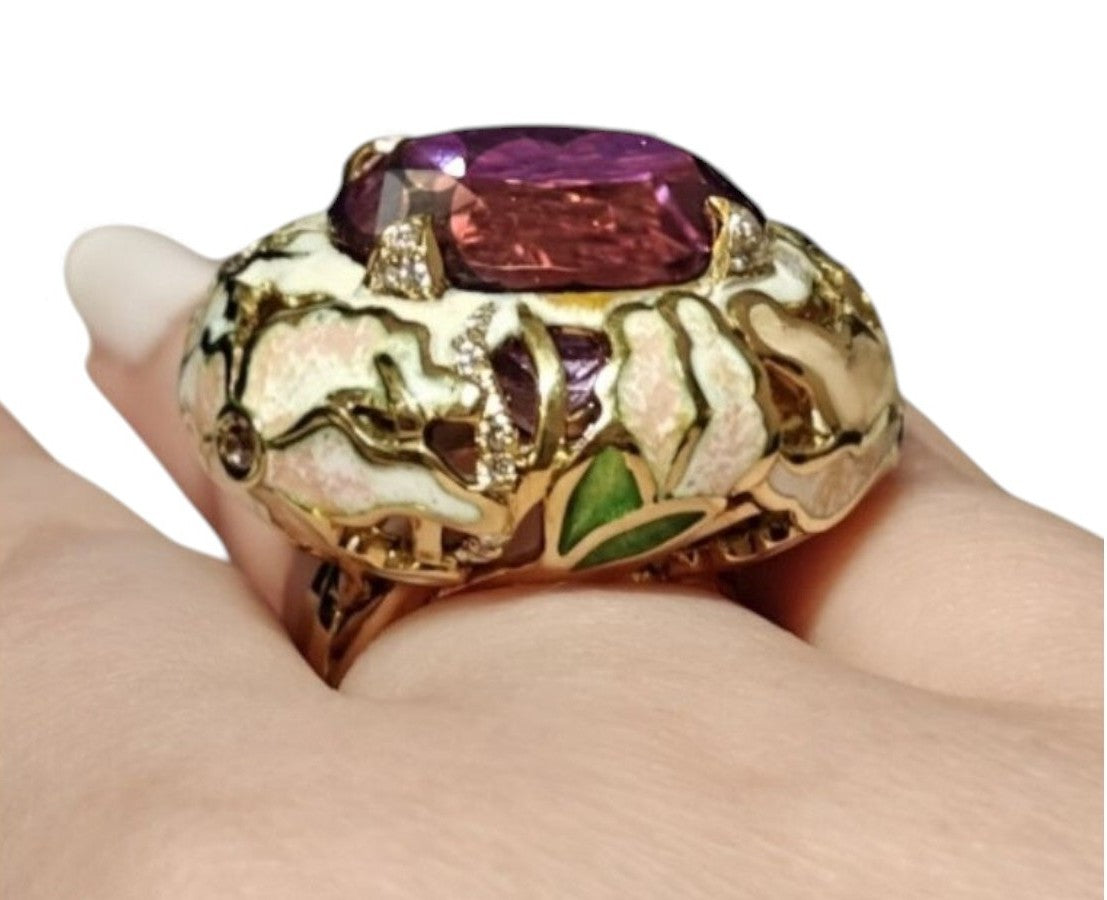 Close on-hand perspective of the ametrine lily ring emphasizing the sculptural enamel lilies, pink sapphire settings, and the brilliance of the 32ct ametrine gemstone.