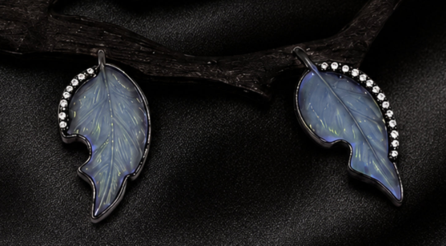Detail of hand-carved angelite leaves framed with diamonds on a nature-inspired persimmon branch pendant by Konforti Atelier.