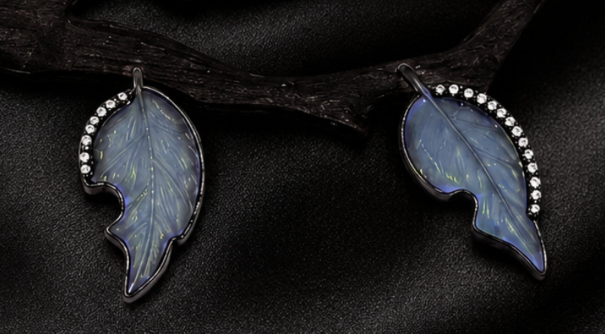 Detail of hand-carved angelite leaves framed with diamonds on a nature-inspired persimmon branch pendant by Konforti Atelier.