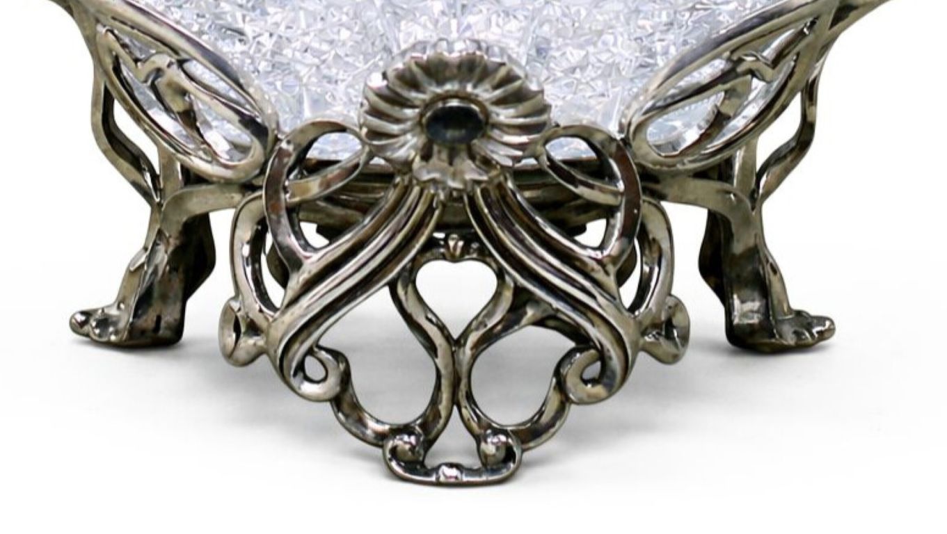 Close-up of the sculptural sterling silver base of an Art Nouveau crystal centerpiece bowl