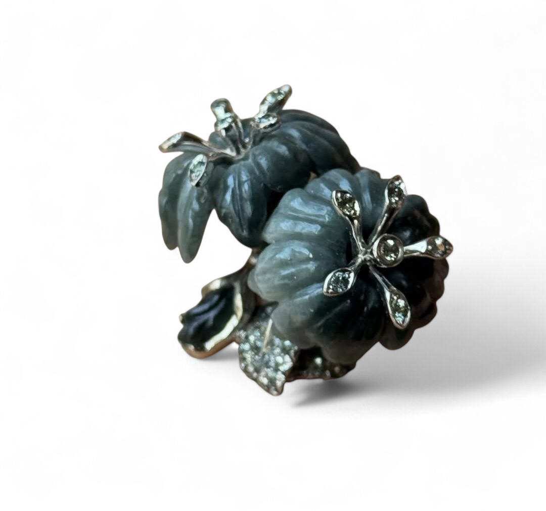 Angled studio image of the Asian Lilly ring showcasing the dimensional carved cat’s eye flowers, grey sapphire accents, and elegant white gold setting.