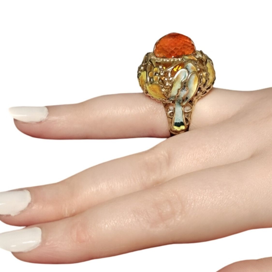 Side-view photo of the Autumn Ring from the Stone Garden Collection worn on the hand, showing the 33ct Madeira citrine briolette pear, hot enamel details, and 0.5ct yellow sapphires set beneath the stone in an 18K yellow gold design.