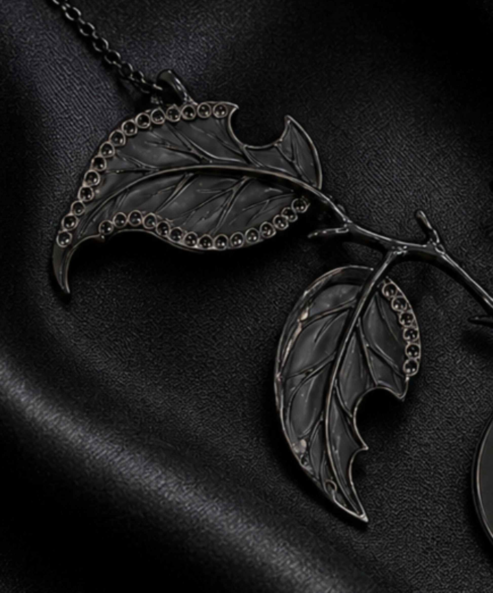 Backside detail of the carved angelite leaves and diamond setting work on the Golden Persimmon pendant, highlighting artisan craftsmanship and black rhodium finish.