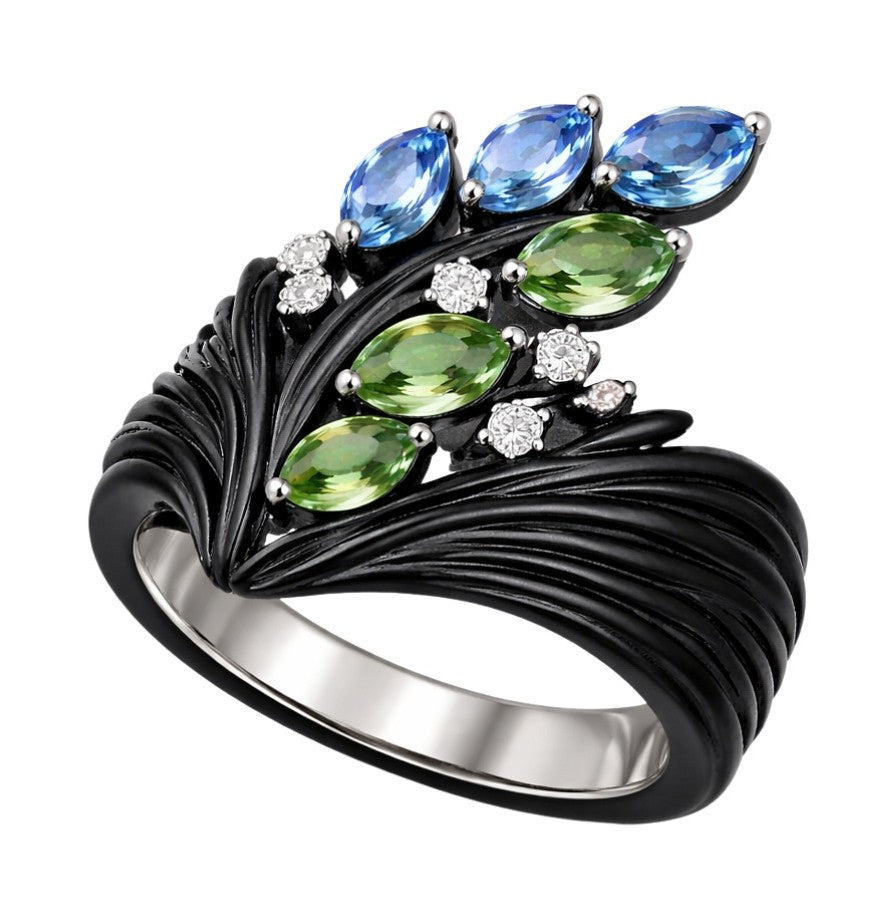 Angled view of sculptural ebony ring with tsavorite leaves, blue topaz and diamond details in white gold