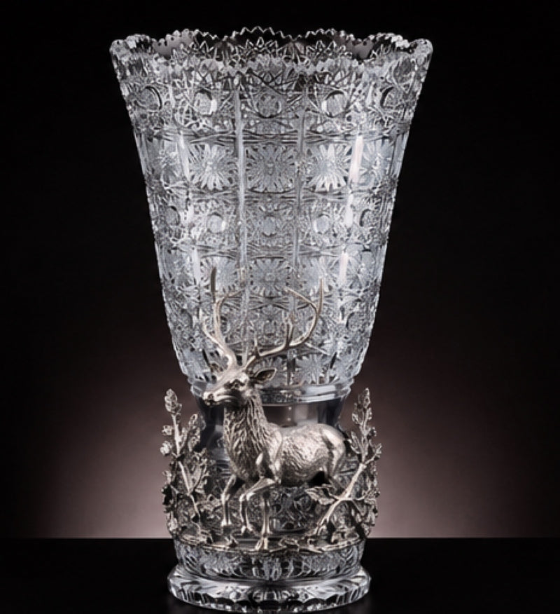 Front view of the Majesty of the Forest Bohemian crystal vase featuring a sculpted sterling silver stag surrounded by branches and foliage.