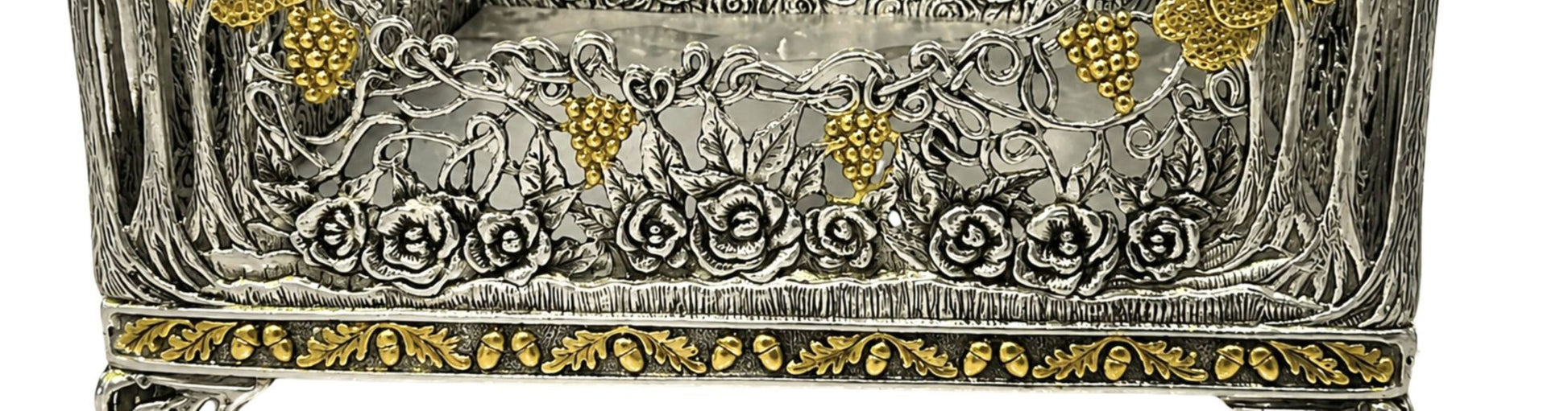 Detailed view of sculpted silver roses, grapevine openwork, and 18K gold gilded grape clusters on Royal Garden napkin holder.