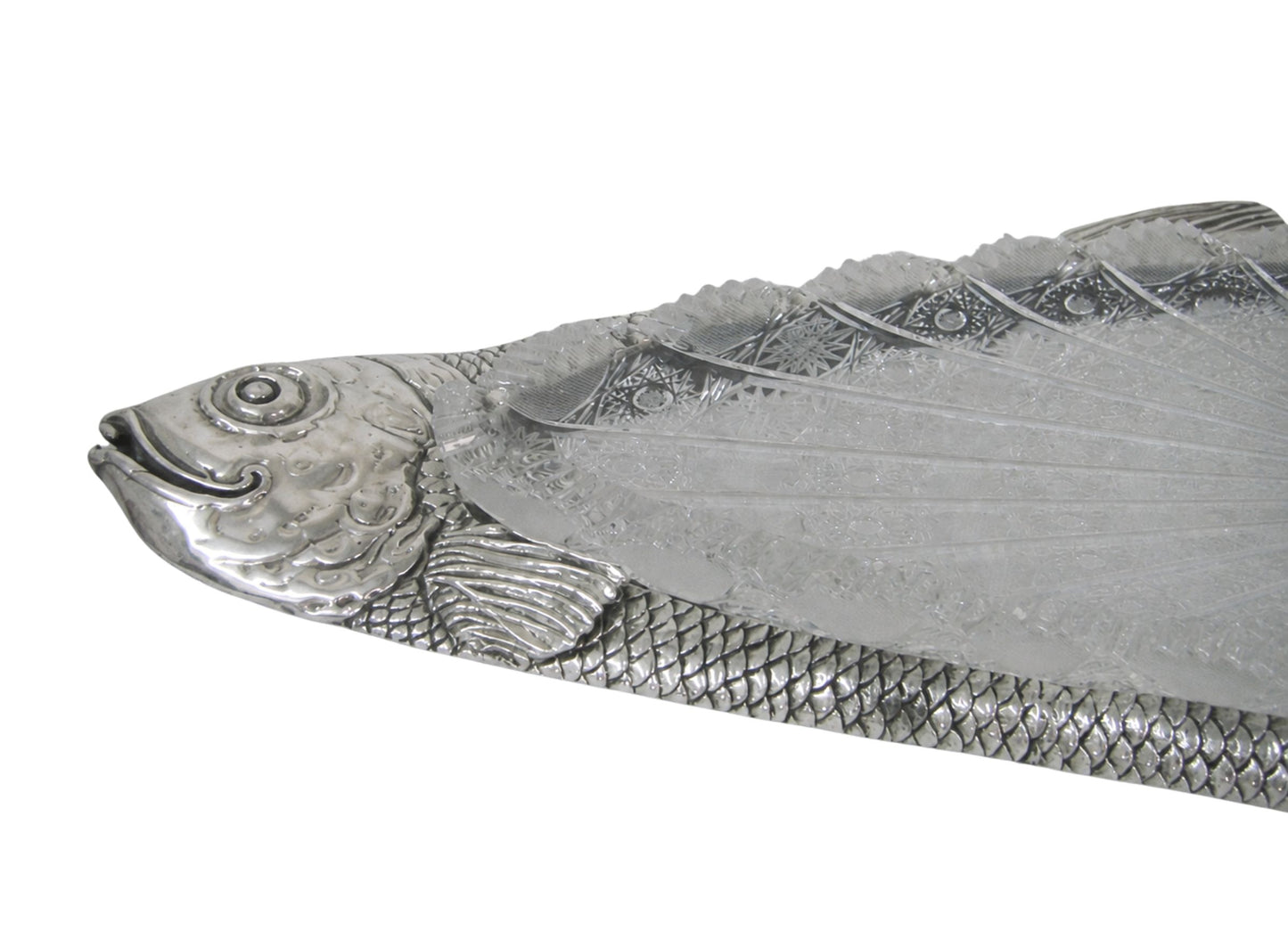 Close up of handcrafted silver carp fish head with detailed engraving, expressive eye and sculptural facial features