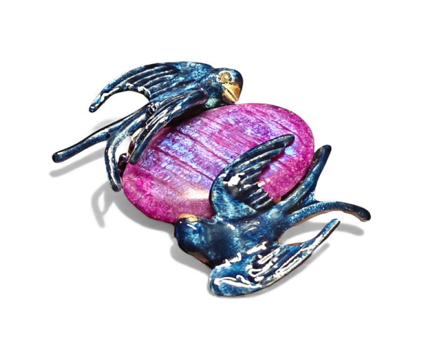 Top view of the Celestial Flight ring highlighting the carved 33ct purple moonstone, layered hot enamel artwork, and shimmering 24K gold accents that give the design its otherworldly glow.