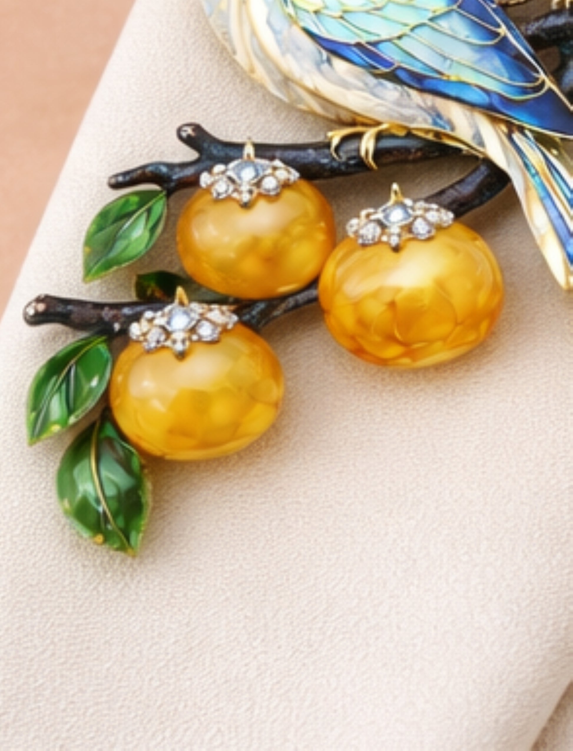 Carved golden lepidolite persimmons with diamond-set calyx details and green chalcedony leaves on the Persimmon Garden 18K gold brooch.