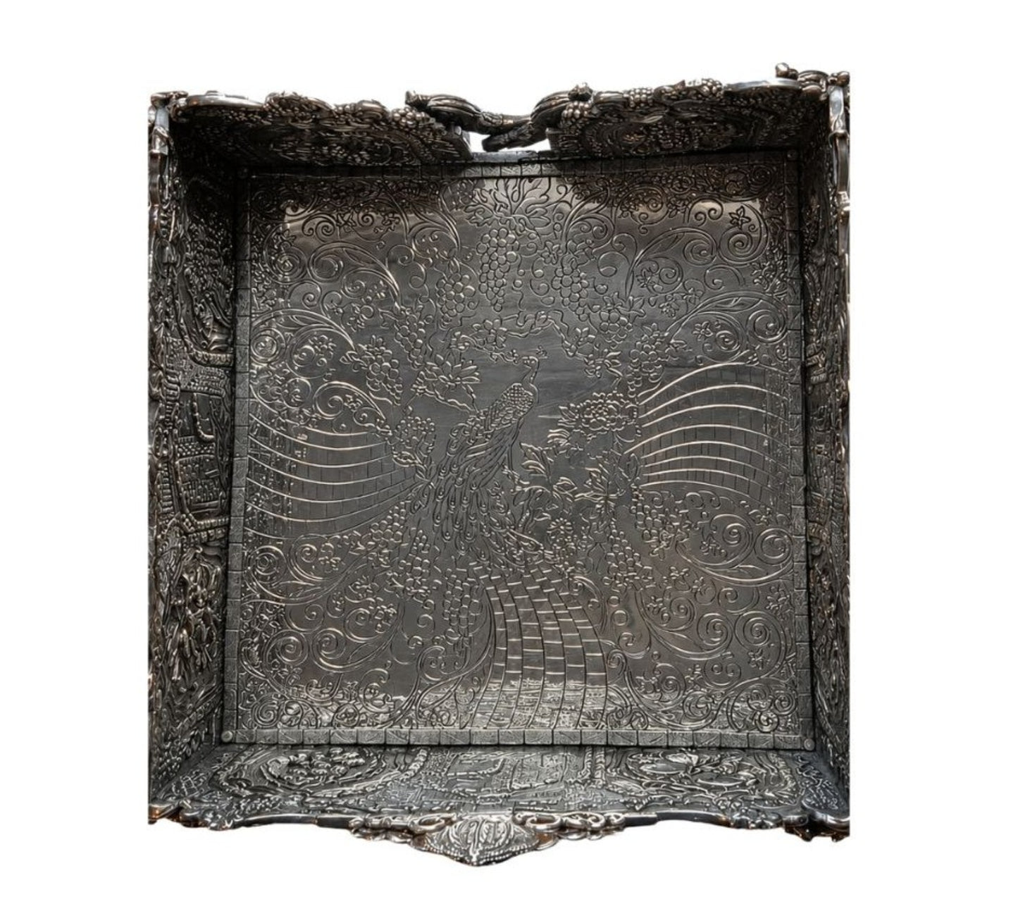 Engraved peacock composition inside Eden Palace sterling silver napkin holder surrounded by flowing Art Nouveau grapevine ornamentation and intricate hand-chased silver detailing.