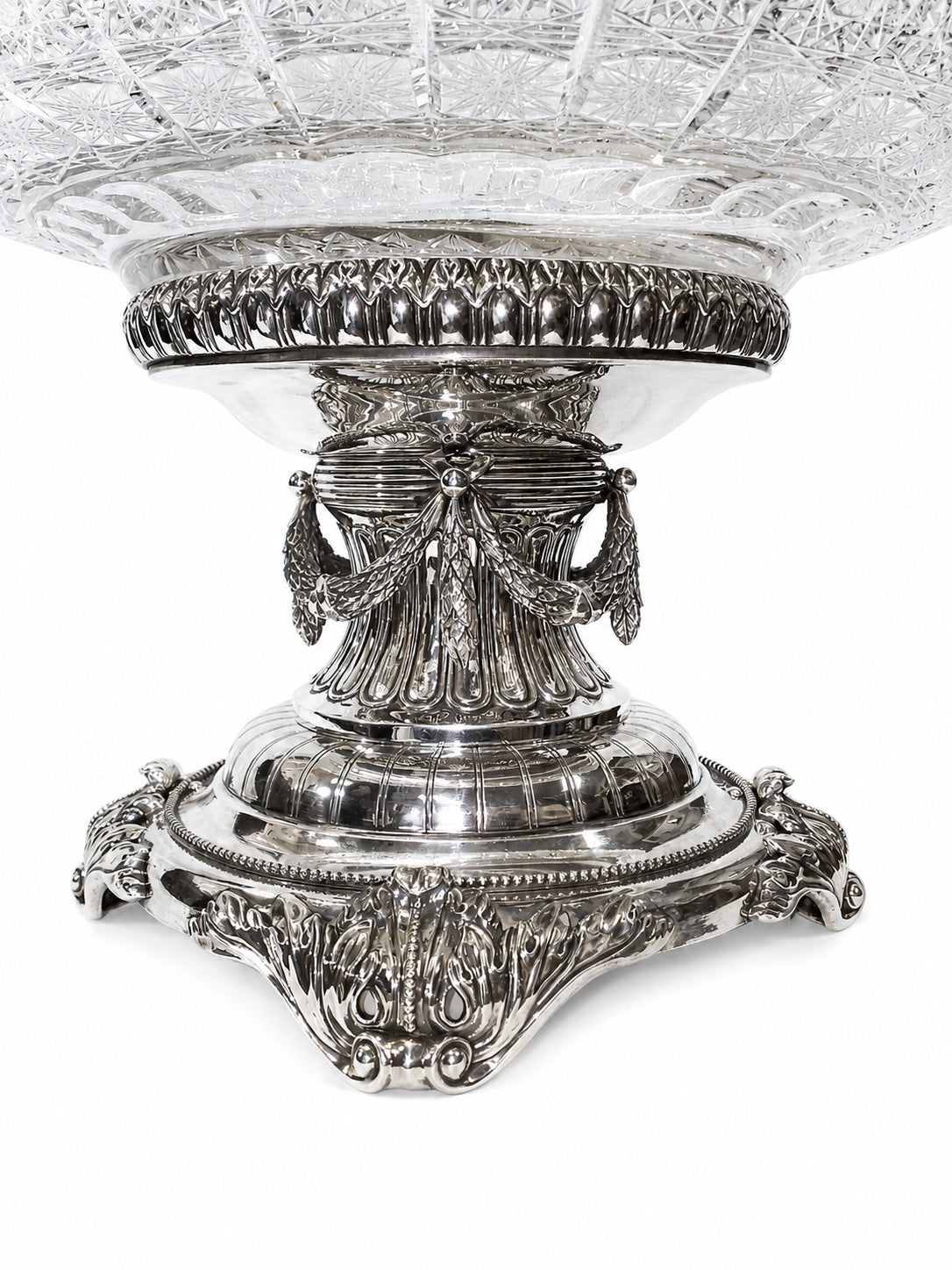 Close-up of handcrafted sterling silver pedestal supporting a cut crystal centerpiece vase inspired by the artistic legacy of Carl Fabergé.