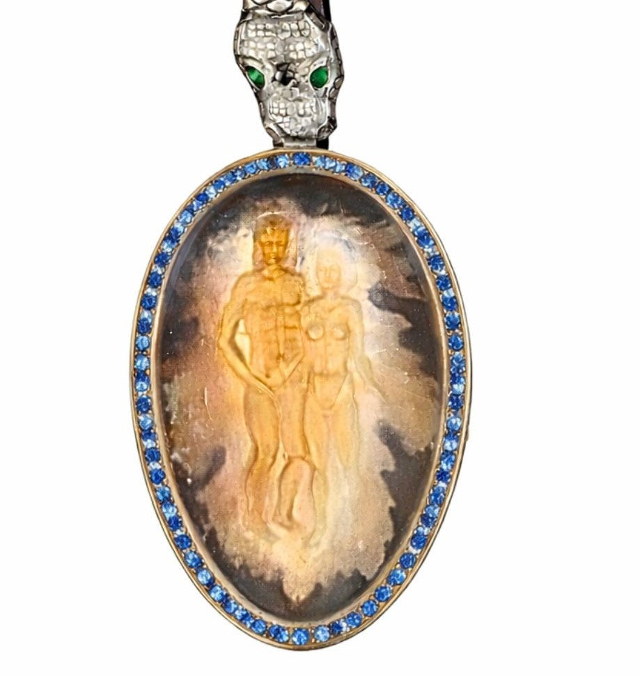 Smoky quartz intaglio of Adam and Eve with 18K gold sculptural overlay, surrounded by blue sapphire set frame