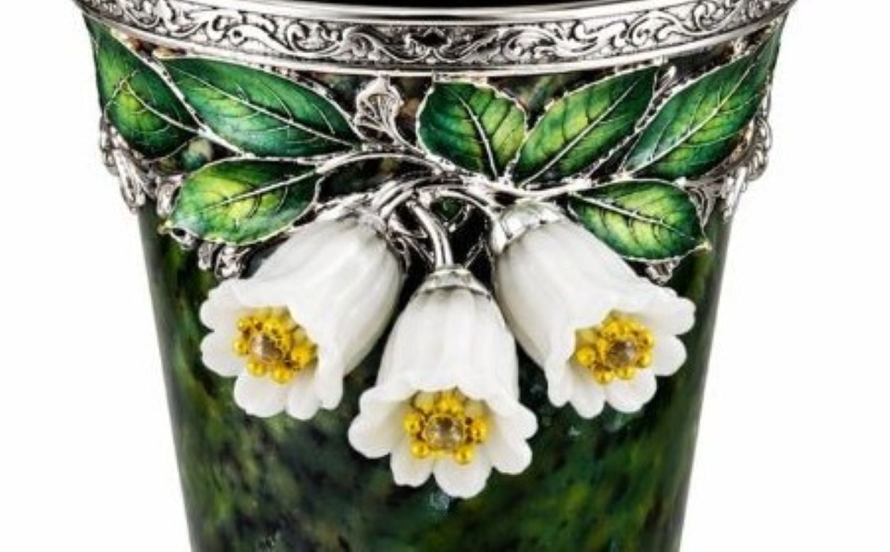 Close up of jade bluebell flowers with yellow sapphire centers set in silver on carved nephrite goblet