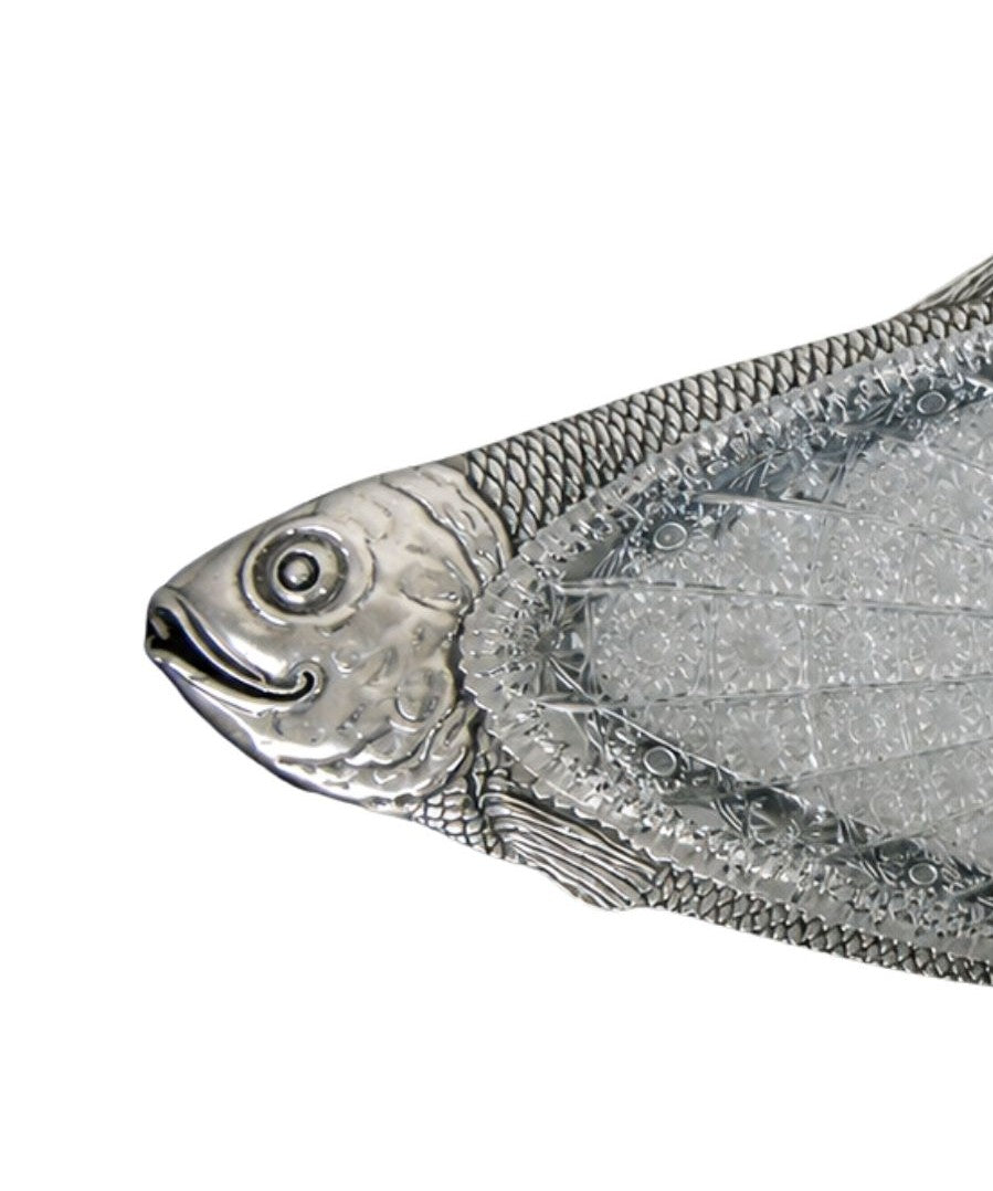 Detail of silver carp fish face with subtle smiling expression, hand chased metalwork and polished contours