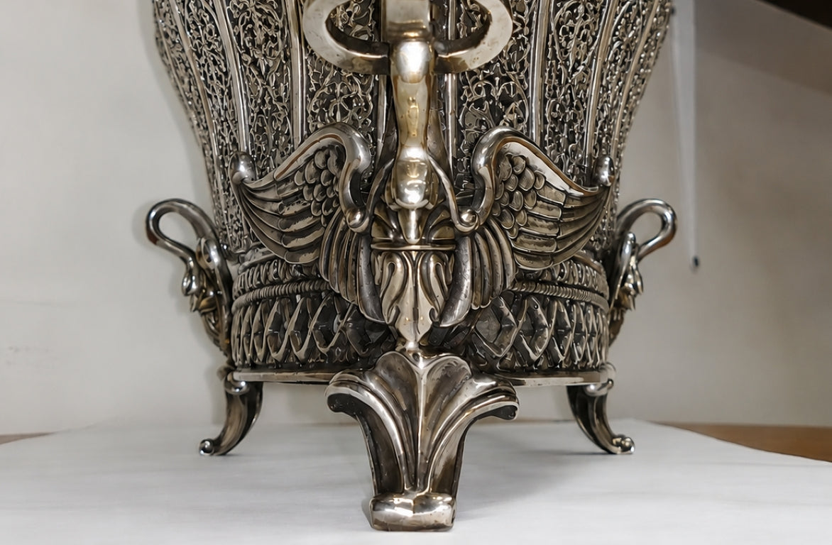 Close-up of heraldic swan sculpture integrated into the body of the Swan Fidelity sterling silver centerpiece vase, symbolizing fidelity, devotion, and elegance.