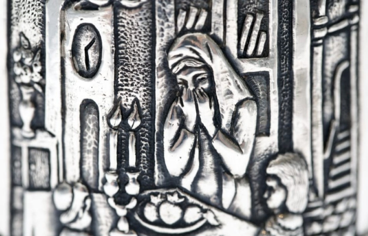 Close up engraved family Kiddush scene on sterling silver cup Judaica narrative detail