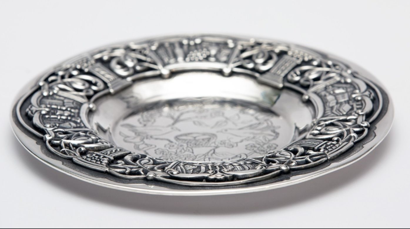Sterling silver Kiddush plate angled view showing depth and sculptural detail