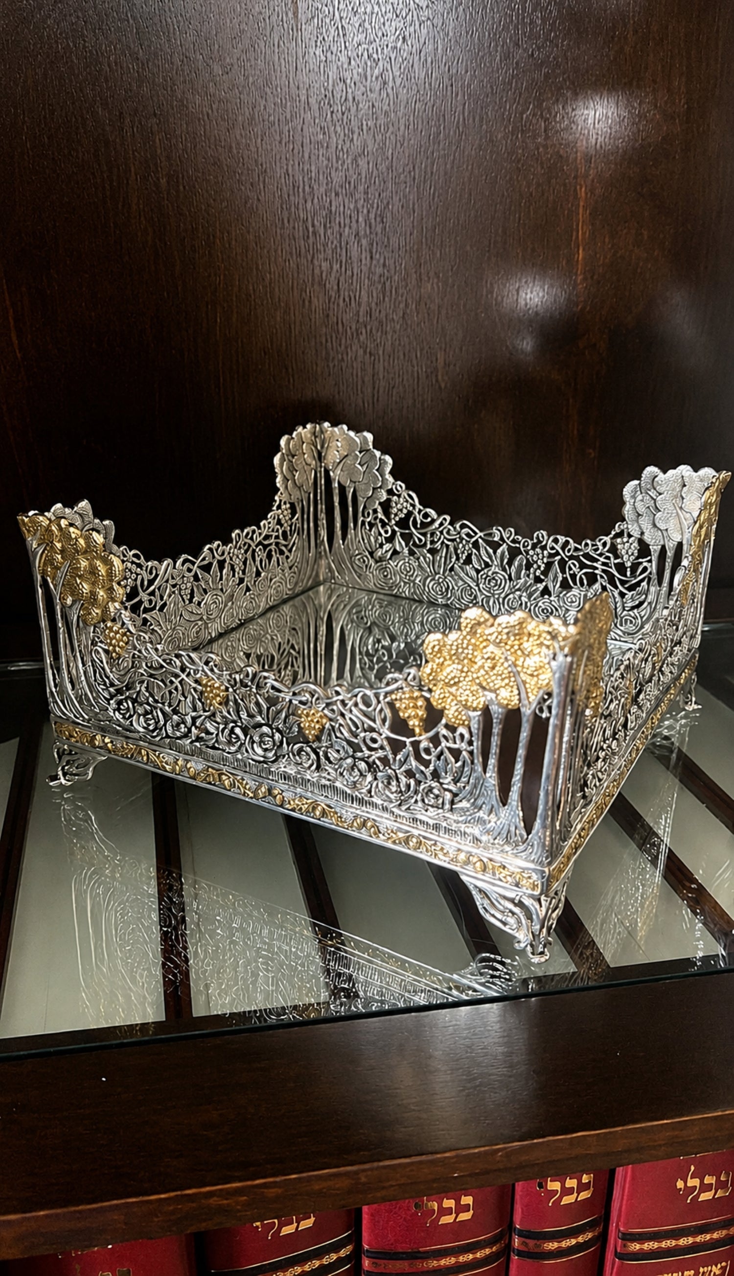 Royal Garden sterling silver and 18K gold botanical napkin holder displayed on glass surface, handcrafted by the Konforti family atelier.