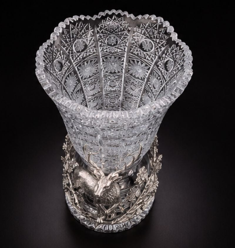 Top view showing the intricate hand-cut geometric and floral decoration of the Bohemian crystal vase above its sculptural sterling silver woodland base.