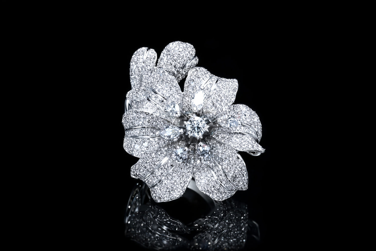 Side view of diamond flower ring in 18K white gold showing sculptural band and pavé-set diamond petals