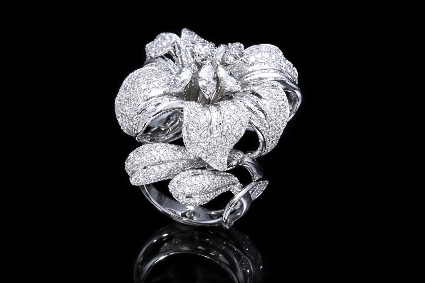 Angled view of luxury diamond floral ring with pavé-set petals and marquise diamond accents in 18K white gold