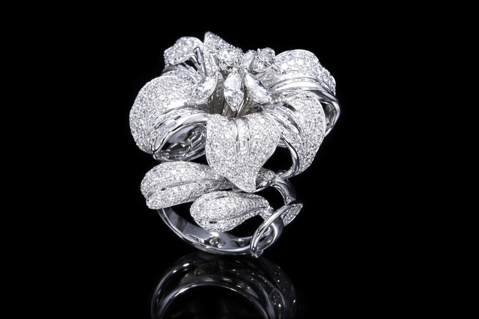 Angled view of luxury diamond floral ring with pavé-set petals and marquise diamond accents in 18K white gold