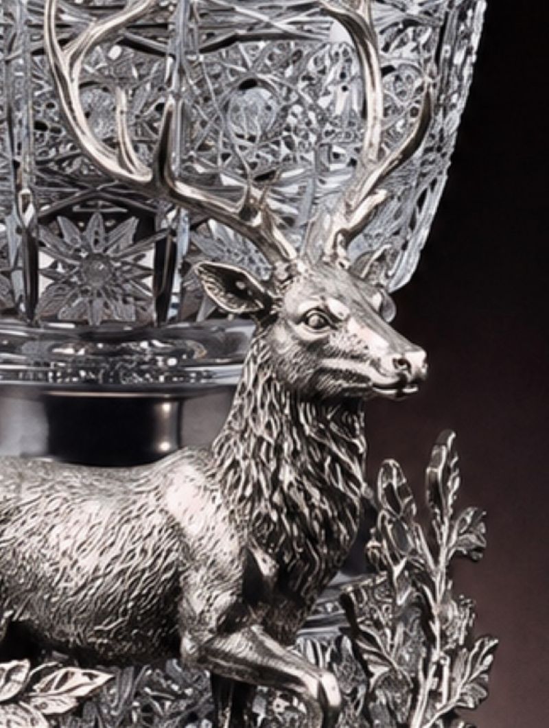 Close-up of the handcrafted sterling silver stag showing detailed antlers, facial features and textured fur beneath the Bohemian crystal vessel.