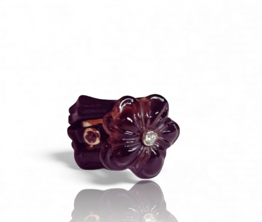 Angled image of the Midnight Blossom ring showing the sculpted smoky quartz flower, the contrast of the 14K pink gold inner ring and ebony wood outer base, and the tourmaline and diamond accents.